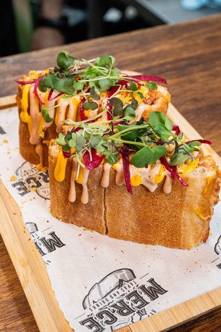 Filled brioche sandwiches on a wooden board