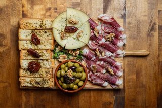 Board of cured ham, cheese and olives